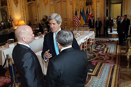 米国務長官ジョン・ケリーと英国外務大臣ウィリアム・ヘイグとウクライナ外相アンドリ・デシュチシア（英語版）の3名が話す様子。2014年3月5日、ウクライナの危機に関するブダペスト覚書閣僚会議をパリで開催した後。