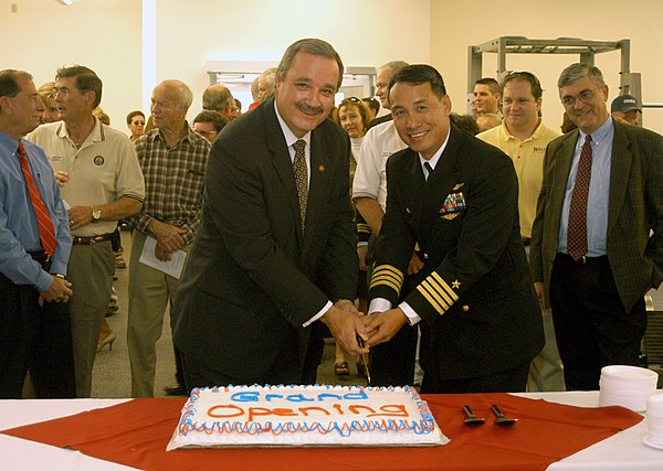 Congressman Jeff Miller and Captain Enrique Sadsad cut a cake at Naval Air Station Whiting Field