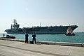 US Navy 091024-N-1056B-002 Line handlers watch as USS Nimitz (CVN 68) arrives for a scheudled post visit. The visit by Nimitz marks the third time in history that an US Navy aircraft carrier has docked pierside in Bahrain.jpg