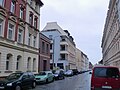 Apartment building (No. 51) in a partially open development, with a former factory building (No. 51a) in the courtyard