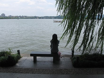 Sitting on a bench, overlooking West Lake
