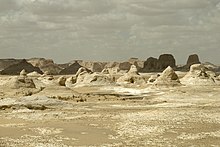 The White Desert is a site of cliffs, dunes and large white chalk rock formations, created through erosion by wind and sand. White Desert, Rock formations in desert landscape 2, Egypt.jpg