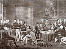 De nombreux diplomates sont assis dans un salon luxueux. Au fond est accroché un tableau montrant l'empereur d'Autriche.