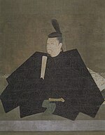 Portrait in three-quarter view of a person seated on the floor in courtly attire carrying a stick like object.