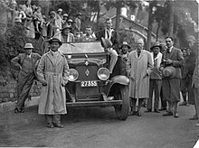 Members of the expedition in Darjeeling, India, in front of the Darjeeling Planters' Club. Expedition leader Hugh Ruttledge, pipe in mouth, is standing to the right of the car, with deputy leader E. O. Shebbeare behind the steering wheel. 1933 British Everest Expedition in Darjeeling.jpg