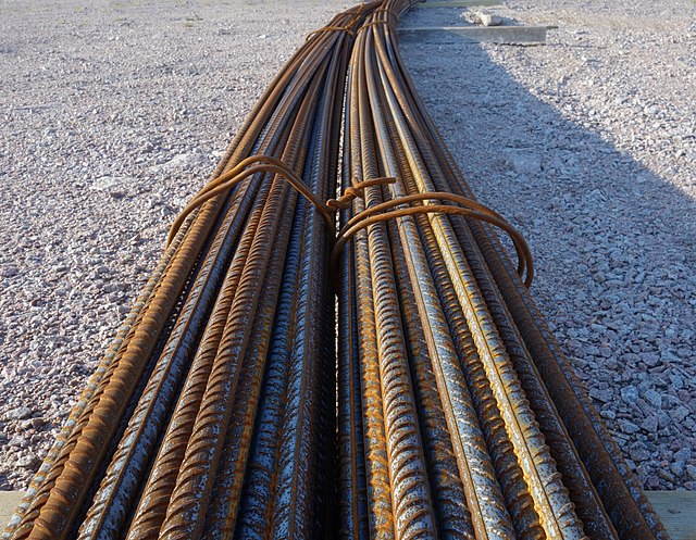 Two bundles of full-length rebar, which will be placed, bent, or cut as required by installation