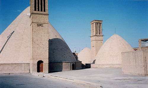 An ab anbar (water reservoir) with double domes and windcatchers (openings near the top of the towers) in the central desert city of Naeen, Iran. Windcatchers are a form of natural ventilation.[1]