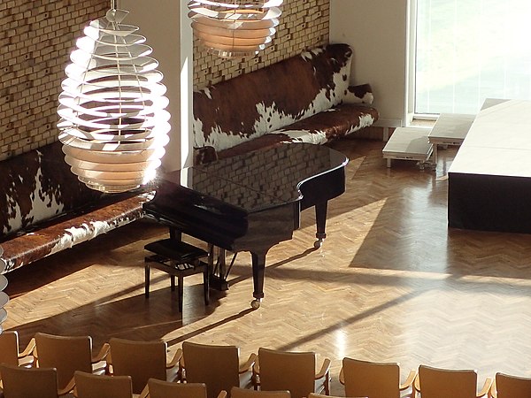 Detail from the Aula, with specially designed lamps and furniture.