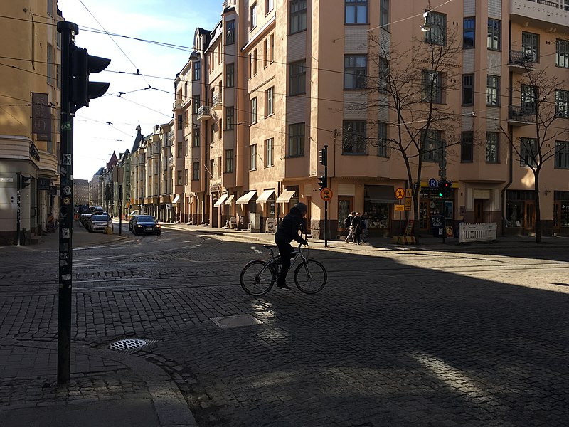 File:Bicyclist along streetcar tracks in cobbled street (41588229734).jpg