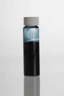 Blue tansy (Tanacetum annuum) essential oil in a clear glass vial, not to be confused with the oil from common tansy (Tanacetum vulgare) which is not blue. BlueTansyEssentialOil.png