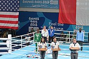 Deutsch: Boxen bei den Olympischen Jugendspielen 2018 Tag 12, 18. Oktober 2018 - Medaillenzeremonie im Fliegengewicht der Mädchen - Gold: Martina La Piana (Italien), Silber: Adijat Gbadamosi (Nigeria), Bronze: Heaven Destiny Garcia (USA); Medaillenübergabe durch Habu Gumel (IOC, Nigeria), Geschenkübergabe durch Dr. Joseph O. Ayeni (Nigeria, AIBA). English: Boxing at the 2018 Summer Youth Olympics on 18 October 2018 – Girl's flyweight Medal Ceremony - Gold: Martina La Piana (Italy), Silver: Adijat Gbadamosi (Nigeria), Bronze: Heaven Destiny Garcia (USA); Medal handover by Habu Gumel (IOC, Nigeria), Gift presented by Dr. Joseph O. Ayeni (Nigeria, AIBA). Español: Boxeo en los Juegos Olímpicos Juveniles de Verano de 2018 en 18 de octubre de 2018 - Ceremonia de la Medalla de peso mosca para niñas - Oro: Martina La Piana (Italia), Plata: Adijat Gbadamosi (Nigeria), Bronce: Heaven Destiny Garcia (Estados Unidos); Entrega de medallas por Habu Gumel (COI, Nigeria), Regalo presentado por Joseph O. Ayeni (Nigeria, AIBA).