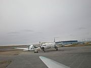 Looking from the cockpit of a Buffalo Airways DC3 at Yellowknife towards a Lockheed L-188 Electra and another DC3. This is the first aircraft purchased by "Buffalo" Joe McBryan.