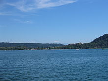 View of Erlach from across Lake Biel. Both the castle and Jolimont mountain are visible toward the right side CH Erlach.JPG