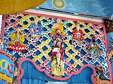 Cao Dai Temple: On top is Buddha, on his right Lao Tzu, on his left Confucius. Under Buddha is Li Bai. On Li Bai's right is the female Boddhisattva Guanyin, on his left is the red-faced warrior Guan Gong. Below Li Bai is Jesus, and below Jesus is Jiang Ziya. Cao Dai Temple Vietnam(2).jpg