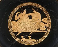 This image has been given the description of a "...courting couple at the symposium" and a "Symposium scene with youths.". Interior of an Attic cup. Artist; Painter from Colmar. Around 500 - 450 BCE. Louvre Museum Cup - Terracotta - 1.jpg