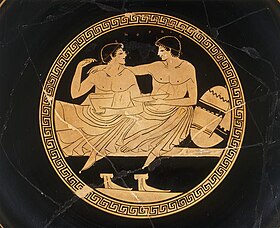 This image has been given the description of a "...courting couple at the symposium." and a "Symposium scene with youths.". Interior of an Attic cup. Artist; Painter from Colmar. Around 500 - 450 BCE. Louvre Museum Cup - Terracotta - 1.jpg