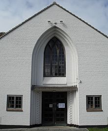 The entrance is set in a deeply recessed pointed arch. Entrance at St Mary's Church, Hampden Park, Eastbourne.jpg