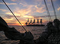 Royal Clipper silhouetted against the sunset