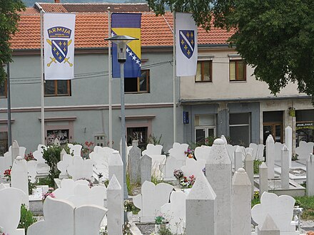 A cemetery in Mostar flying the flag of the Army of the Republic of Bosnia and Herzegovina (left), the flag of Bosnia and Herzegovina, and the flag of the Republic of Bosnia and Herzegovina