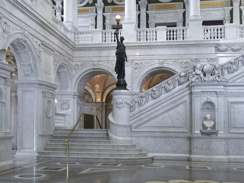 File:Great Hall. View of grand staircase and bronze statue of female figure on newel post holding a torch of electric light, with bust of Thomas Jefferson at right. Library of Congress Thomas Jefferson LCCN2007684261.tif