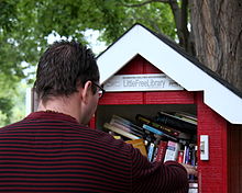 A reader browsing a Little Free Library LittleFreeLibraryPatron.jpg