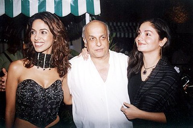 Bhatt (right) with her father Mahesh Bhatt and actress Mallika Sherawat in 2004.