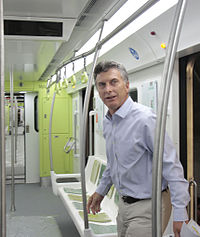 Macri entrando em um vagão de metrô novo e colorido