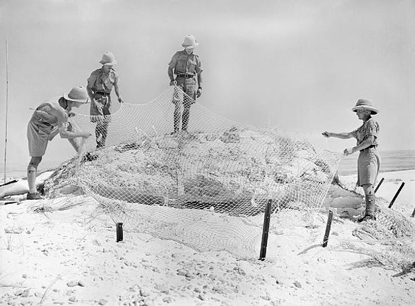 Infantry camouflage a gun position at Mersa Matruh.