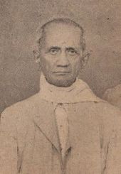 A sepia-toned photograph of an old man