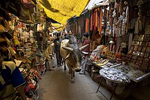 Stray bull in a market in Varanasi People, cattle in Varanasi, Uttar Pradesh, India (2005).jpg