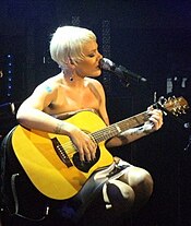 "We R Who We R" was compared to fellow pop singer Pink's (pictured) track "Raise Your Glass" for their similar inspiration. Pink 3.jpg