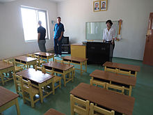 Classroom on a cooperative farm in North Korea configured for passive learning School classroom, Tongbong Cooperative Farm (14996466640).jpg