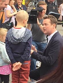 Mulhern performing a magic trick to a child at Chessington World of Adventures during filming of the show. Stephen Mulhern 2015.jpg