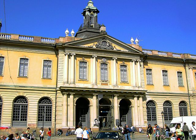 Image of the Swedish Stock Exchange building that houses the Swedish Academy, photographed during daytime.
