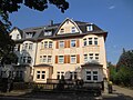 Apartment building in half-open development with a rear building as well as a front yard and enclosure