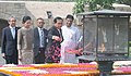 The Prime Minister of the Kingdom of Thailand, General Prayut Chan-o-cha paying floral tributes at the Samadhi of Mahatma Gandhi, at Rajghat, in Delhi on June 17, 2016. Mrs. Naraporn Chan-o-cha is also seen.jpg