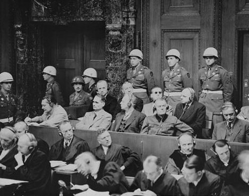 Defendants at the Nuremberg trials listening to translated evidence through headphones