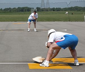 FAI Team Race model about to be caught by pit man during pit stop practice at the 2004 World Championships in Muncie, IN. Pressurized fueling tank with pressure gauge can be seen on the pitman's left arm. Tr pitstop muncie.jpg