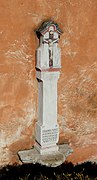 Wayside cross (1735) at the bell tower of Saint Erasmus Church, Trassem, Germany.