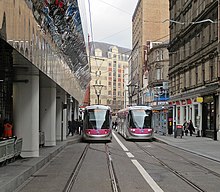 Two CAF Urbos 3 trams at Grand Central tram stop, the one on the left arriving, and the one on the right about to depart for Wolverhampton.