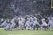 Cameron Carson kicks for UMass during a win over Army in 2023 UMass vs. Army (53296503657).jpg