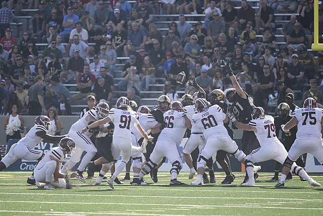 Cameron Carson kicks for UMass during a win over Army in 2023