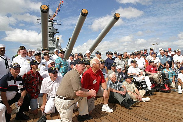 Former crew members of USS Missouri pose for photos after the Anniversary of the End of World War II ceremony in 2003.