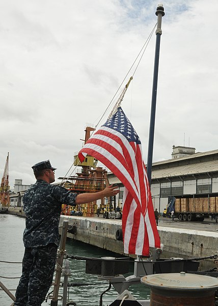 File:US Navy 110421-N-NL541-076 Fire Controlman 2nd Class Jordon Babin lowers the national ensign on the fantail of the guided-missile frigate USS Thach.jpg