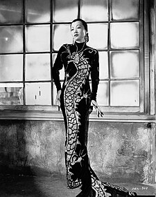 Asian-American fashion icon Anna May Wong in the 1934 film Limehouse Blues, wearing a reintepretation of the Chinese cheongsam designed by Travis Banton.