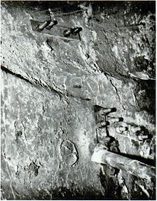 A crack in one of The Arts of Peace statues, repaired with tie-plates and bolts. Arts of Peace - crack held together by tie plates and bolt - 1971.jpg