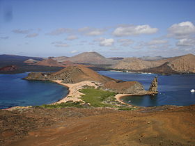 Udsigt over den vestlige del af øen Bartolomé med Pinnacle Rock (forgrund) og Santiago Island (baggrund) til højre fra toppen af ​​øen.