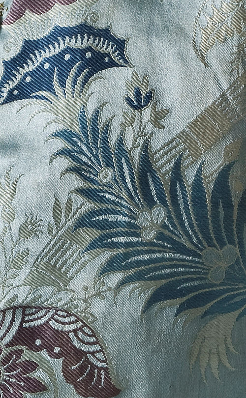 Bizarre silk of circa 1715 features a geometric, diagonal design overlaid with stylized flowers and leaves.  Silk satin with supplementary weft patterning bound in twill (lampas).  Detail of a sleeved waistcoat, Los Angeles County Museum of Art, M.2007.211.40.