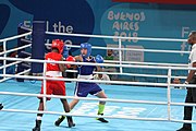 Deutsch: Boxen bei den Olympischen Jugendspielen 2018 Tag 12, 18. Oktober 2018 - Finale Fliegengewicht Mädchen – Martina La Piana (Italien, blau) schlägt Adijat Gbadamosi (Nigeria, rot) 5-0; Ringrichter ist James Beckles (Trinidad und Tobago). English: Boxing at the 2018 Summer Youth Olympics on 18 October 2018 – Girl's flyweight Gold Medal Bout - Martina La Piana (Italy, blue) beats Adijat Gbadamosi (Nigeria, red) 5-0; Referee is James Beckles (Trinidad and Tobago). Español: Boxeo en los Juegos Olímpicos Juveniles de Verano de 2018 en 18 de octubre de 2018 - Combate a medalla de oro de peso mosca para mujeres: Martina La Piana (Italia, azul) le gana a Adijat Gbadamosi (Nigeria, roja) 5-0; El árbitro es James Beckles (Trinidad y Tobago).