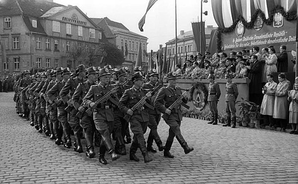 Members of the East German Volkspolizei parading through the streets of Neustrelitz in 1955. They are armed with World War II German StG 44 rifles.